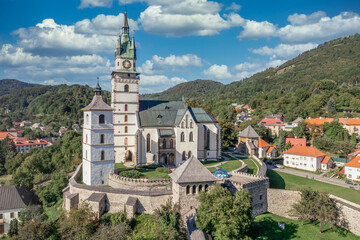 Aerial view of Gothic St. Caterina fortified church in Kremnica, surrounded by double walls, guard towers, gate tower, moat above the medieval walled town center guarding the gold mines in Slovakia