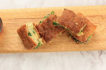 Martabak Telur is Popular Street Food in Indonesia. Egg, Spring Onion Wrapped with Thin Flour Batter