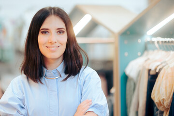 Store Manager Standing with Arms Clothes in front of Merchandise