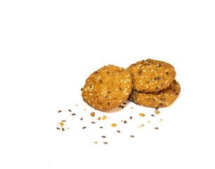 Three oatmeal cookies with cereals and nuts on a white plate.
