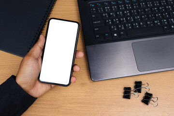 Smartphone showing white screen on desk