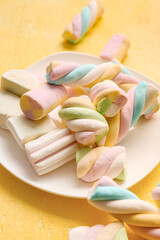 Fototapeta na wymiar Plate with sweet marshmallows on color background, closeup