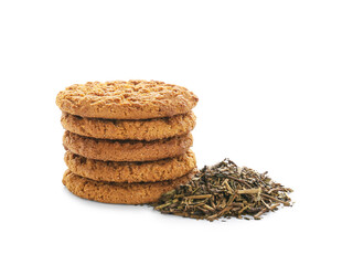 Tasty hojicha cookies and dry leaves on white background