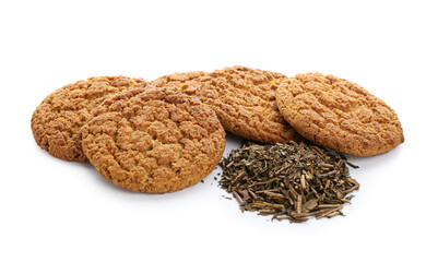 Tasty hojicha cookies and dry leaves on white background