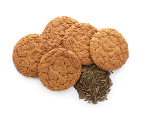 Tasty hojicha cookies and dry leaves on white background