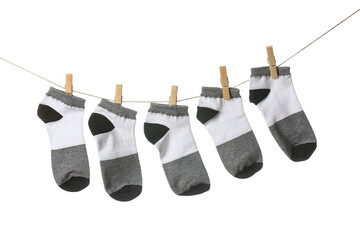 Many socks hanging on clothesline against white background