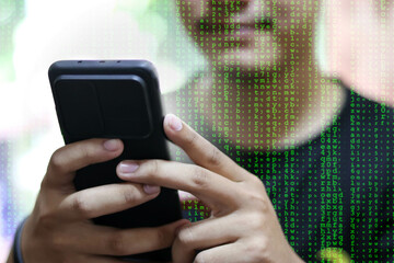 darknet and hacking concept. Hacker with cellphone. Man using dark web with smartphone. Mobile phone fraud, online scam and cyber security threat. Scammer using stolen cell. AR data code.