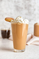 Glass of tasty Tiramisu Latte on table
