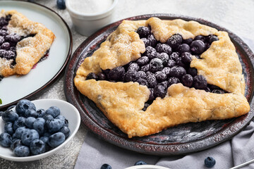 Plate with tasty blueberry galette on table, closeup