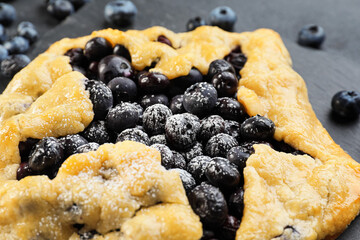Tasty blueberry galette on table, closeup