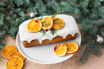 Dessert stand with tasty Christmas stollen with fir branches on color background