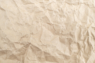Recycled brown creased paper background from a paper packing. Crumpled brown paper texture concept