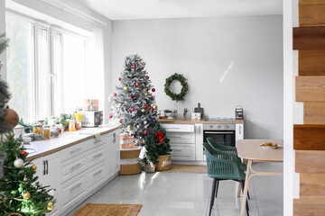 Interior of modern kitchen with beautiful Christmas tree