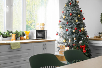 Interior of modern kitchen with beautiful Christmas tree