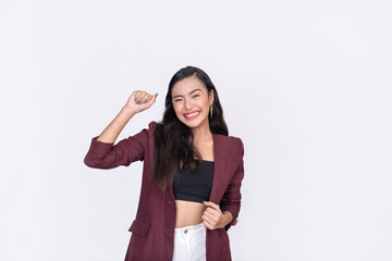An excited asian woman in a partying mood. Wearing a purplish brown blazer and black tube top....
