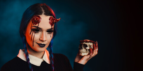 woman with scary halloween makeup with bloody horns dark background - obrazy, fototapety, plakaty