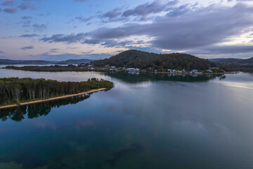 Sunrise waterscape with cloud covered sky