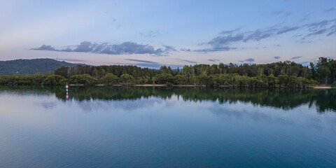 Sunrise waterscape with cloud covered sky