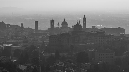 Fototapeta na wymiar Bergamo, Italy. Amazing aerial landscape of the old town. Humidity and pollution in the air. Fall season. Morning time. Bergamo, one of the most beautiful city in Italy