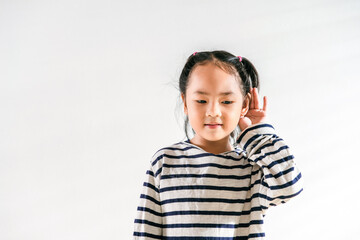 Happy Positive cute Asian little toddler kid girl holding ear with hand listening to a hearing for...