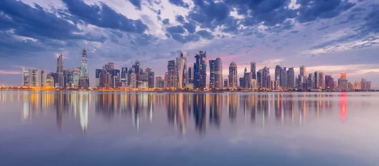 Fotobehang The Panoramic skyline of Doha, Qatar during sunrise © hasan