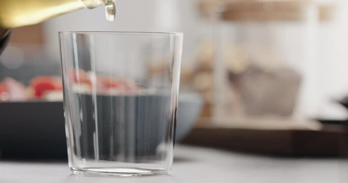 Slow motion pour ginger beer in tumbler glass with copy space