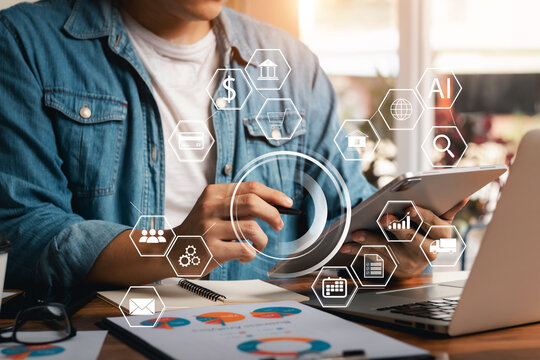 Businessmen use laptops and digital tablet computers in offices with virtual interface icons network diagram, at the office in the morning.