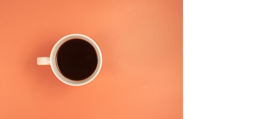 White cup with coffee on a orange  background. top view, flat,  minimalism, copy space. Card