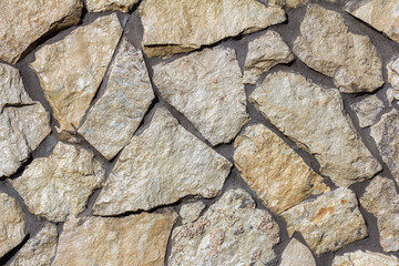 The texture of a stone wall. A stone wall as a background or texture.