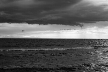 the sky in the clouds before the storm in Lake Onega in black and white
