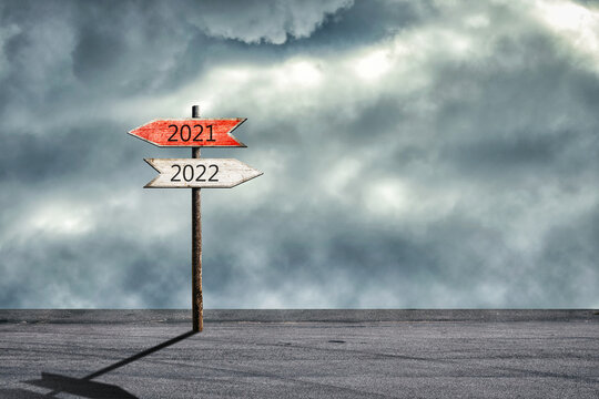 2021, 2022. Wooden sign with arrows pointing in different directions. Right direction. Right choice. Plans for the New Year.