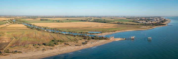 Aerial shot of fishing huts with typical italian fishing machine, called "trabucco",Lido di Dante, Fiumi Uniti, Ravenna near Comacchio valley.