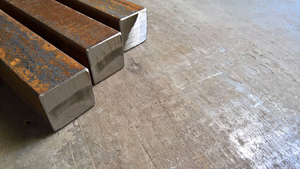 Background and texture of old rusty metal and metal profiles, metal bars with a square section. Master welder's workshop