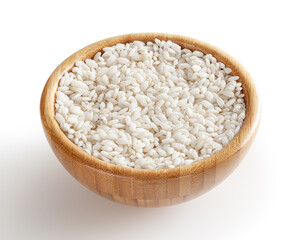 Uncooked arborio rice in wooden bowl isolated on white background with clipping path