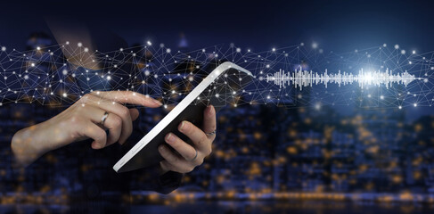 Audiobook audio technology. Digital sound track on hand. Hand touch white tablet with digital hologram sound track, wave sign. Listening to music on mobile devices. Voice recognition.