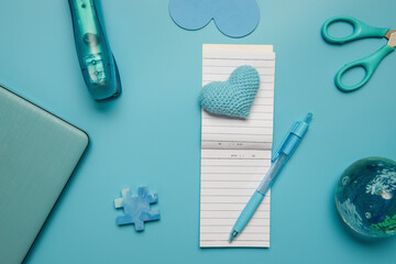 stationery and laptop over blue background, education, business or learning concept, flatlay of school or home office items. 