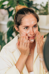 A young woman beauty blogger broadcasts live streaming to review makeup and cosmetic products on...