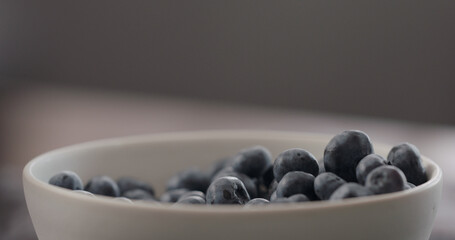 ripe blueberries from white bowl closeup