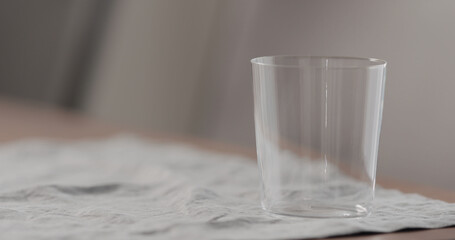 empty tumbler glass on linen cloth