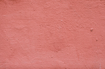 Fototapeta premium Abstract background from red old plaster on the wall.