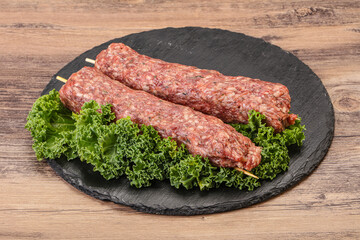 Raw minced beef kebab skewer