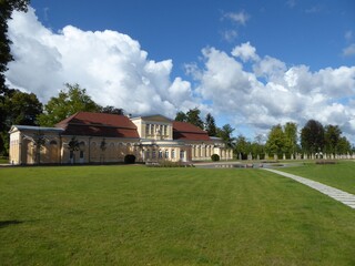 Fototapeta na wymiar The extensive castle park of Neustrelitz, Mecklenburg-Western Pomerania, with the Orangery to the left