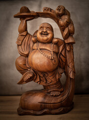wooden monk buddha on grey background isolated