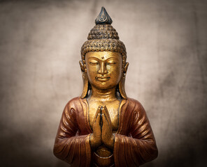 Golden Buddha on grey vintage background