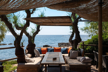 A table with comfortable benches to relax on the east coast of the Spanish island of Mallorca....