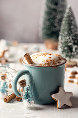 Christmas drink. Cup of hot chocolate with cinnamon in blue mug and gingerbread stars cookies with...