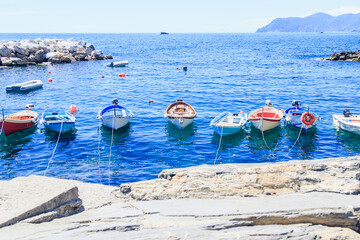 View of the sea and many adjacent boats in the Cinque Terre National Park, an area on the rugged...