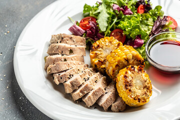 Salad with chicken fillet, fresh vegetable grilled corn and sauce, Healthy food, keto diet, diet lunch concept. Top view