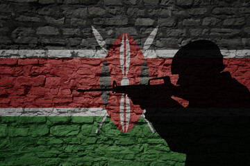 Soldier silhouette on the old brick wall with flag of kenya country.