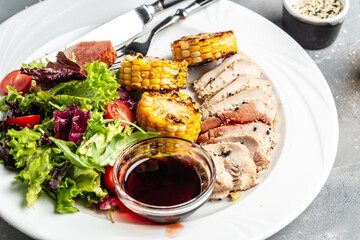Green salad with chicken breast, grilled corn and sauce. Healthy fats, clean eating for weight loss